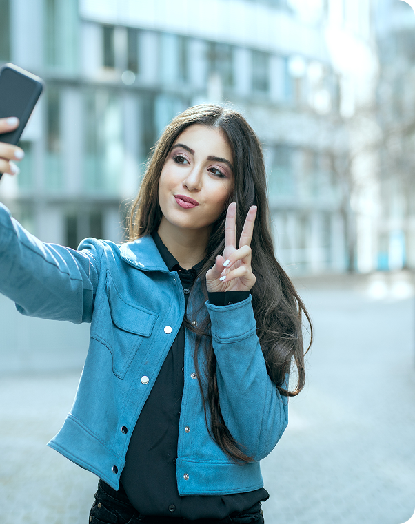 Girl showing peace sign wearing blue denim jacket